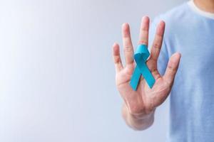 Blue November Prostate Cancer Awareness month, Man in blue shirt with hand holding Blue Ribbon for support people life and illness. Healthcare, International men, Father, Diabetes and World cancer day photo