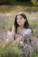 Beautiful young girl on lavender field. photo