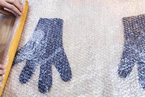 craftsman rolls felted gloves to mat with pin photo