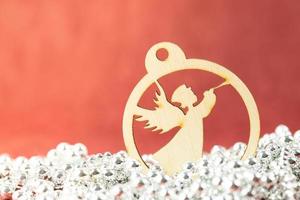 A wooden Christmas ornament on a red background photo