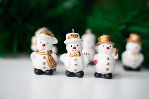 Christmas snowmen on the background of green branches photo