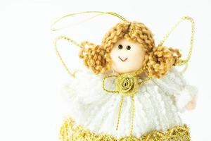 A cloth angel with a smiling face. Handmade Christmas ornament. White background with place for text. photo