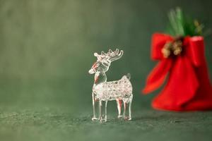 A glass Christmas ornament in the shape of a reindeer. Christmas banner. photo