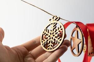 A wooden Christmas ornament held in the hand photo