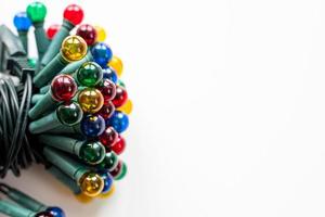 Various colored Christmas lights for a Christmas tree on a white background photo