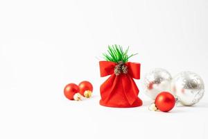 decoración navideña sobre un fondo blanco. bolas rojas del árbol de navidad y una campana. lugar para el texto. foto