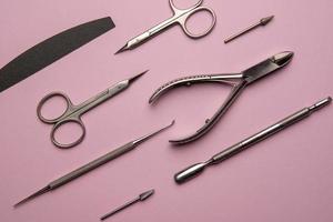 Set of manicure tools and accessories on a pink background. Hardware manicure,Flat lay. photo