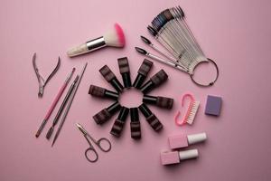 Set of manicure tools and accessories on a pink background. Hardware manicure,Flat lay. photo