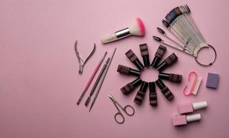 Set of manicure tools and accessories on a pink background. Hardware manicure,Flat lay. photo