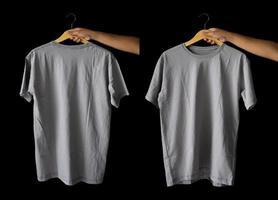 hand holding hanger plain t-shirts for mockup design. blank t-shirts from the front and back view isolated background photo