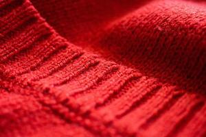 closeup red knitted woolen fabric texture background photo