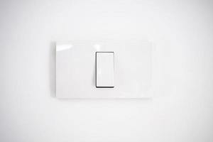 white lighting switch on concrete wall background photo