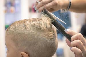 Close up of boy having a haircut. photo