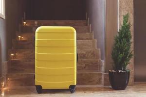 Yellow suitcase in a hallway. photo