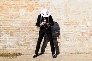 Unrecognizable photographer taking picture with medium format camera. photo