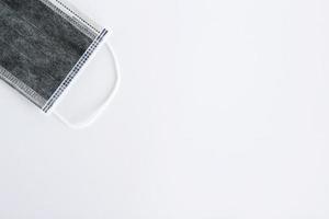 Flat lay on medical face mask on white background with copy space. photo