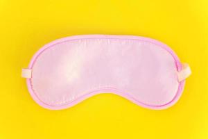 Sleeping mask on yellow background photo