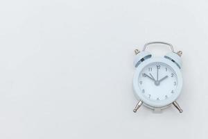 Simply flat lay design Ringing twin bell vintage classic alarm clock Isolated on white background. Rest hours time of life good morning night wake up awake concept. Flat lay top view copy space. photo