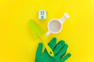 Flat Lay with gardening tools on yellow background photo