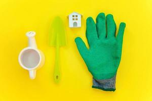 Flat Lay with gardening tools on yellow background photo