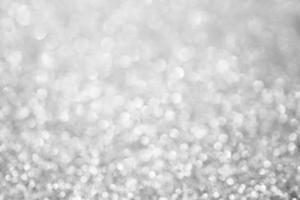 Abstract blur silver glitter sparkle defocused bokeh light background photo