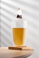 Tea glass cup with tea bag on the wooden  table photo