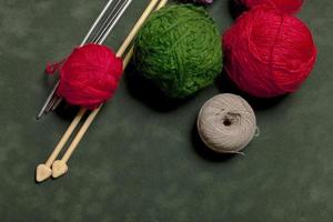 Set of colored threads and wires for knitting on a tiny background photo