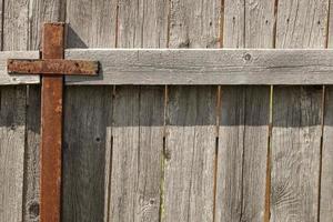 Wooden grey fence with metal pillar photo