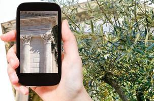 tourist taking photo of temple Maison Carree