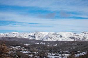 snow capped mountains with blue sky and clouds photo