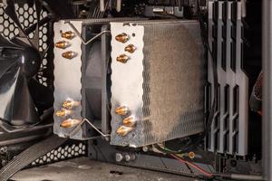 dust clog layer on tower type cpu cooler in opened pc case photo