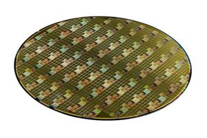 Silicon wafer with microchips used in electronics for the fabrication of integrated circuits. Whole circle isolated on white background. photo