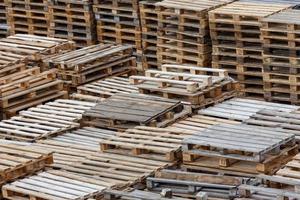 full frame background of used wooden pallet stacks - perspective view from above photo