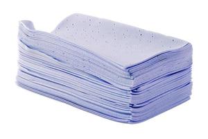 stack of purple liquidless and powderless laundry detergent squares sheets isolated on white background photo