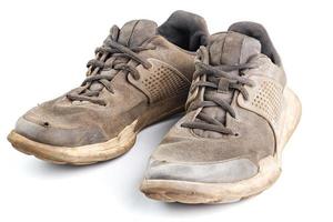 a pair of weared dirty sneakers isolated on white background photo