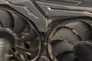 dusty black pro gaming graphic card fan blades with dust, airborne fur and hairs close-up photo