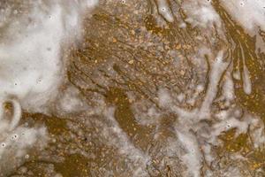 Floor with soap sud waste in car washing garage. Full frame close-up with selective focus. photo