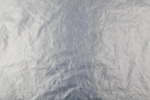 full frame background of flat crumpled semi-transparent polyethylene film photo