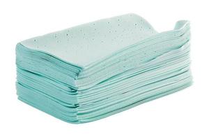 stack of green liquidless and powderless laundry detergent squares sheets isolated on white background photo
