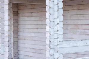 white painted wooden pillars made of crossed planks photo