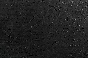 water drops on black flat rubber surface macro background photo