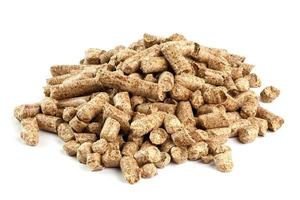 Small pile of pressed wooden sawdust pellets isolated on white background. Biofuel and pet litter, mulch. photo