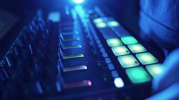 Professional DJ Plays a Beat Sampler with Color Drum Pads and Samples in Studio Environment. Beatmaker Plays edm Tracks on Party in a Nightclub. Electronic Musical Instrument. Unrecognizable person video