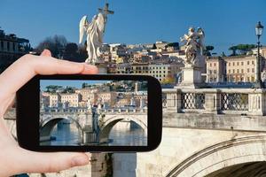 tourist taking photo of Angel statues in Rome