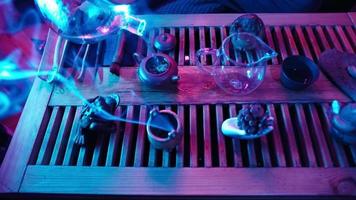 Traditional Tea Making on a Board for a Tea Ceremony by Neon Lighting. Man Pours Boiling Water into a Teapot. Unrecognizable person. video