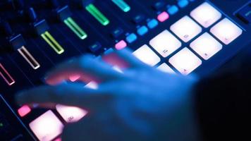 Professional DJ Plays a Beat Sampler with Color Drum Pads and Samples in Studio Environment. Beatmaker Plays edm Tracks on Party in a Nightclub. Electronic Musical Instrument. Unrecognizable person video