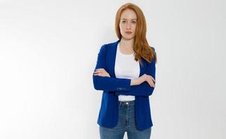 Happy red haired business woman in template blank white t shirt and stylish jacket isolated on gray background. Self career and job consulting knowledge. Young ceo entrepreneur and casual clothes photo