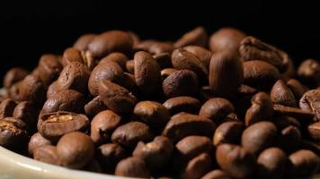 Slow motion of roasted coffee beans falling. Organic coffee seeds. video