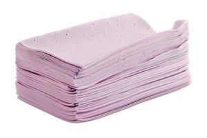 stack of pink liquidless and powderless laundry detergent squares sheets isolated on white background photo