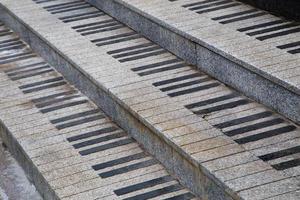 public granite stairs stylised as piano keys - close-up view photo